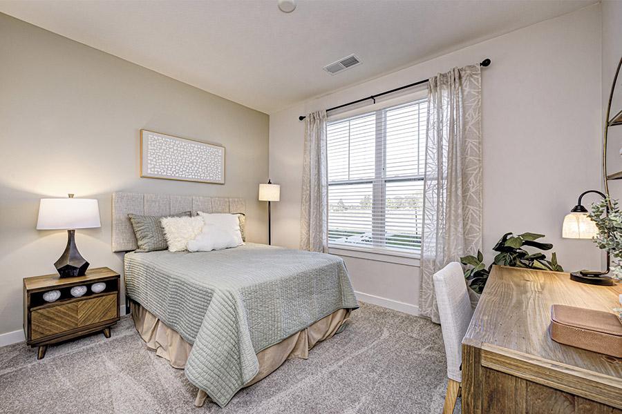 Apartment bedroom with window and lamps